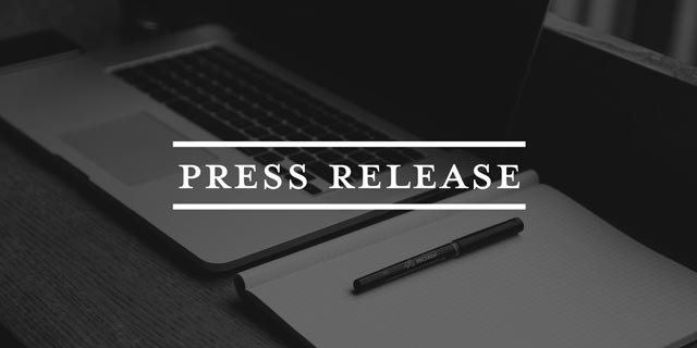 press release text over computer and notepad image