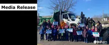 school kids hold signs with plow names infront of a Town of Pelham Plow