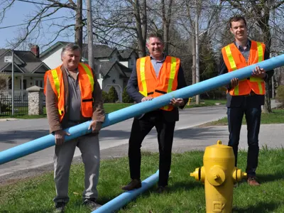 Mayor of Pelham, Town of Pelham Director of Public Works and Niagara West MPP pose with pvc watermain and hydrant