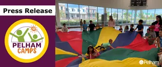 Press Release Town of Pelham Campers in a gym playing with a parachute