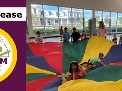 Press Release Town of Pelham Campers in a gym playing with a parachute