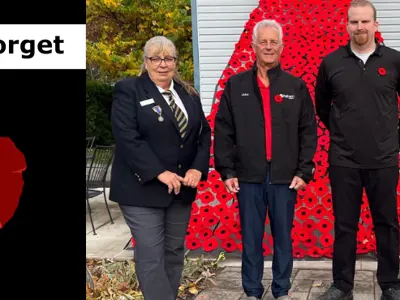 Lest we forget and poppy image with group of veterans receiving a poppy