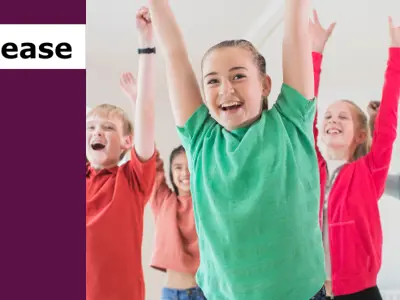 Press Release with image of youth with hands raised and smiling participating in a drama activity